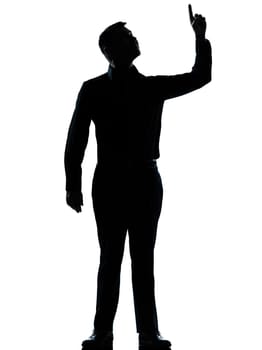 one caucasian business man poiting up happy  silhouette standing Full length in studio isolated on white background