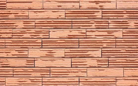 Modern wall with orange ribbed bricks