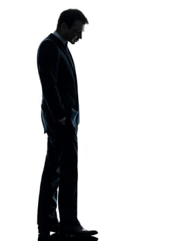 one caucasian sad business man  looking down  in silhouette studio isolated on white background