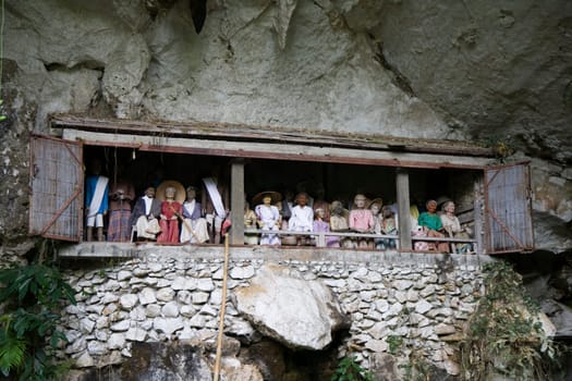 Wood carved effigy, called tau tau placed in the cave looking out over the land