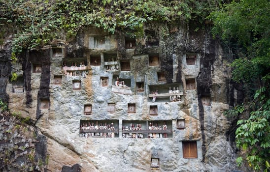 Wood carved effigy, called tau tau placed in the cave looking out over the land