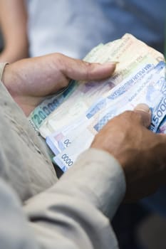 Counting money during a cock fight in Sulawsi, Indonesia