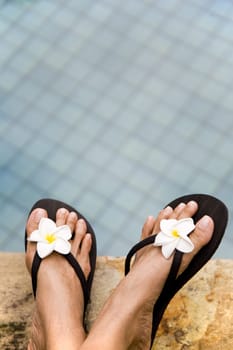 Relaxing on the side of the swimming pool