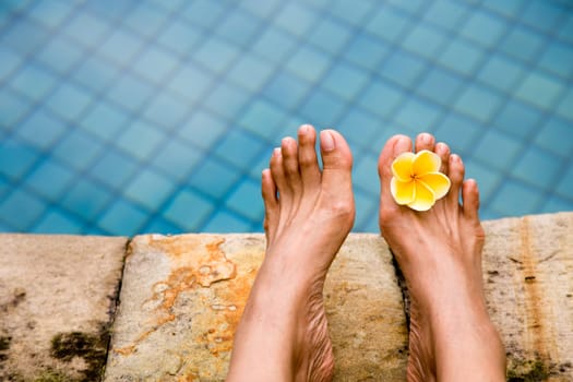 Relaxing on the side of the swimming pool