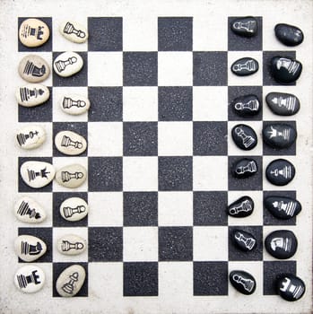 A stone chess board with stone chess pieces