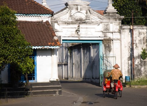 Street scene with becak in the Kraton area in Solo, Indonesia