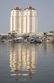 Slum area with apartments in the background in Jakarta, Indonesia