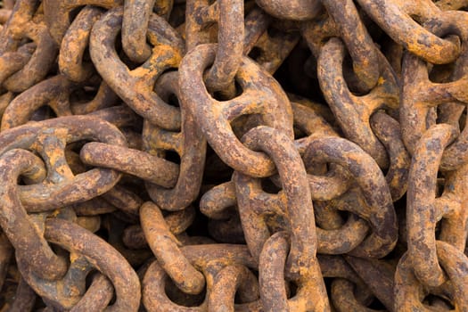Rusty steel ship chains on a shipyard