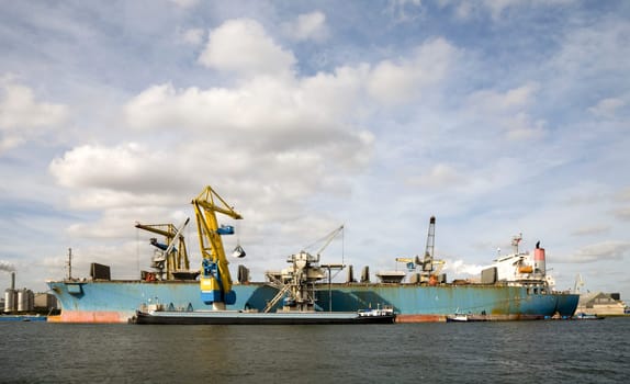Cargo ship is unloading in the port of Amsterdam