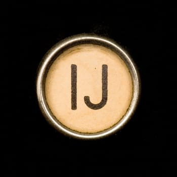 The IJ button on a complete alphabet of an antique typewriter