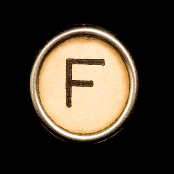 The F button on a complete alphabet of an antique typewriter