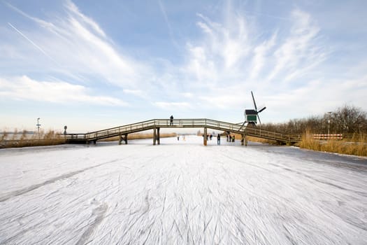 Skating scene with Dutch historic windmills at Groot-Ammers