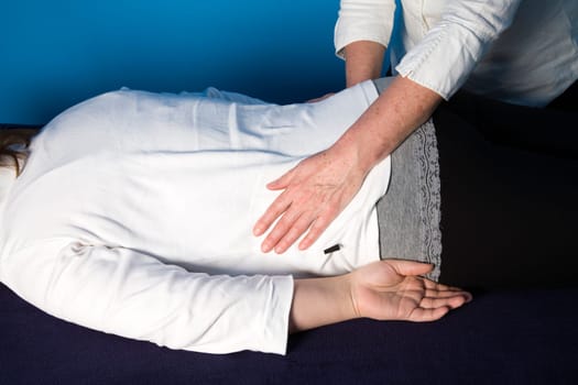 A young woman is getting a reiki treatment