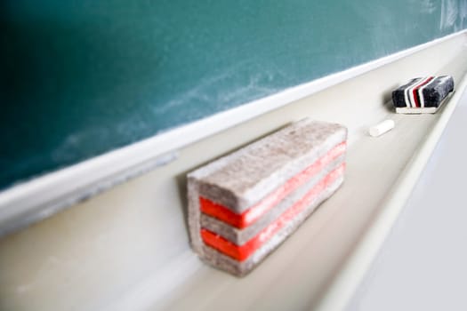 Used green chalkboard with eraser and chalk