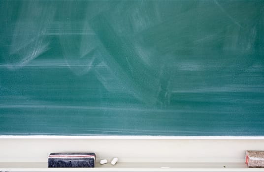 Used green chalkboard with eraser and chalk