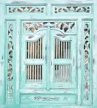 Traditional Indonesian wood carved window with shutters