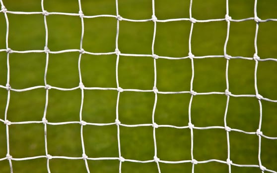 Soccer goal net with a soccer field background