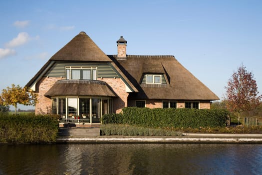 New built house on the waterfront in traditional Dutch country style