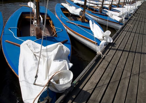 Many blue sailing boats in the marina