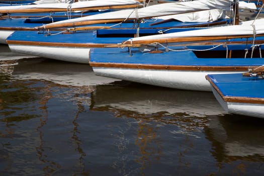 Many blue sailing boats in the marina