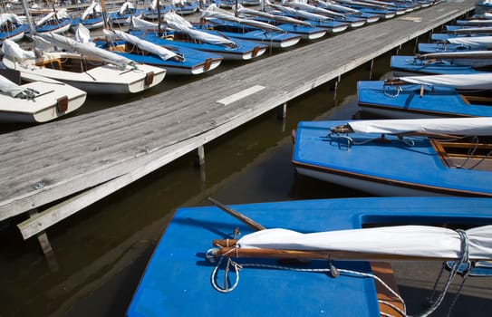 Many blue sailing boats in the marina