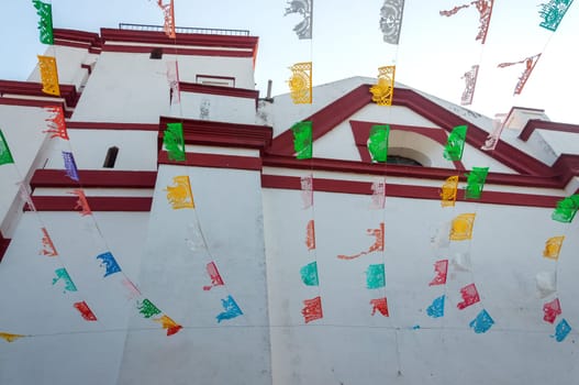 View of white church with waving flags