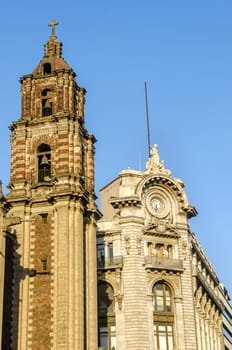 Old historic building next to spire of a church