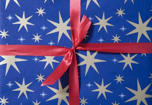 Christmas present wrapped in red ribbon