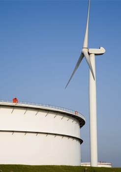 Oil storage and modern wind turbine in the Port of Rotterdam, Holland