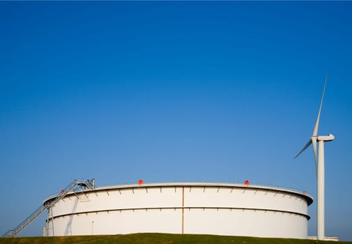 Oil storage and modern wind turbine in the Port of Rotterdam, Holland