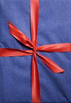 Christmas present wrapped in red ribbon