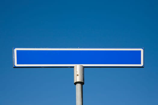 Road sign against a blue sky
