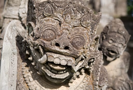 Balinese carved statue guarding a temple