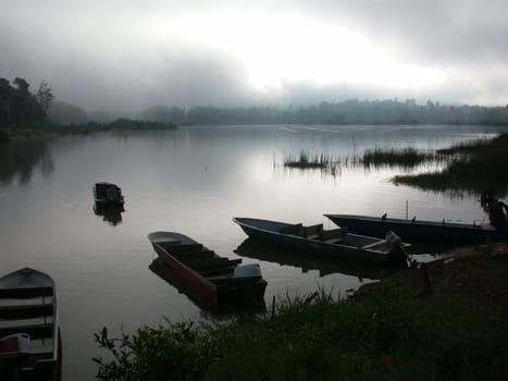 A misty sunset over a lake in Malaysia