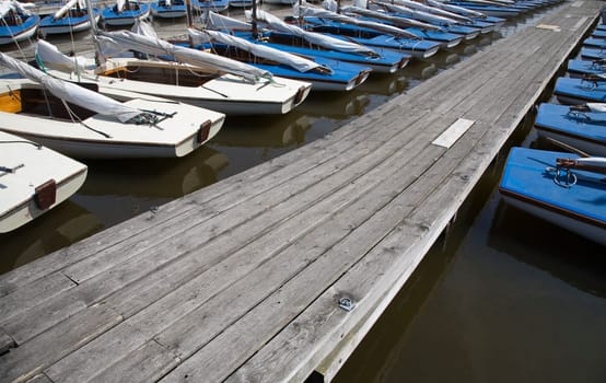 Many blue sailing boats in the marina