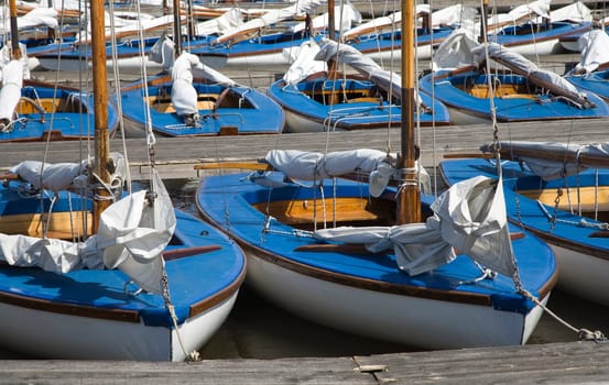 Many blue sailing boats in the marina