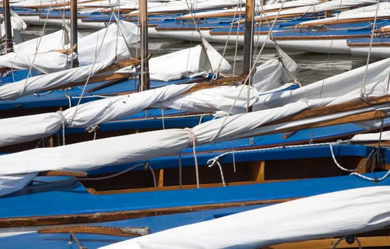 Many blue sailing boats in the marina