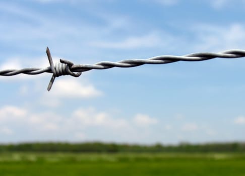 Barb wire against blue sky