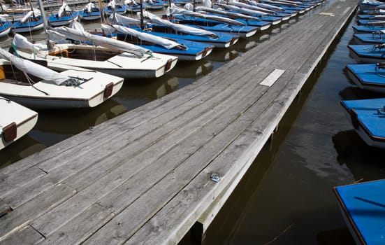 Many blue sailing boats in the marina