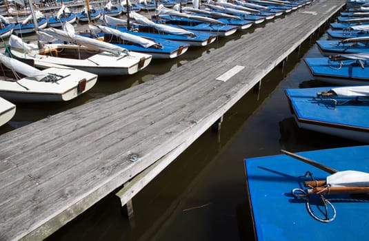 Many blue sailing boats in the marina