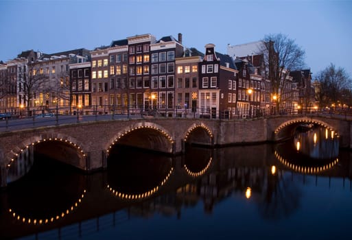 Canal junction at night in Amsterdam,Holland