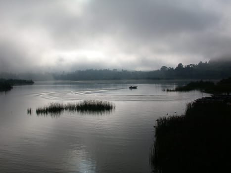 A misty sunset over a lake in Malaysia