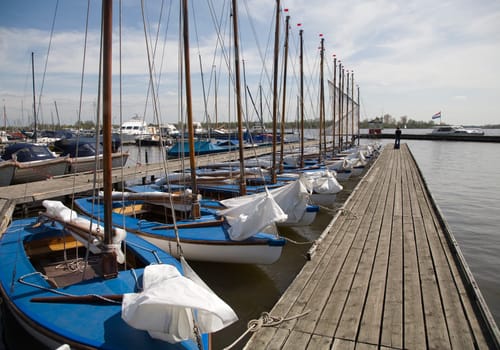 Many blue sailing boats in the marina