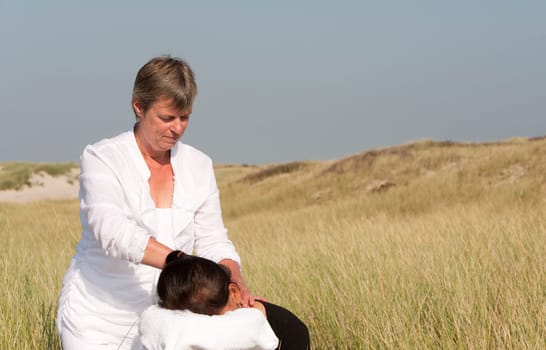 Chair massage in the dunes on the island Ameland, the Netherlands
