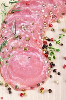 Dried sausage on a wooden board (Kindzukas). Traditional sausage in Lithuania.