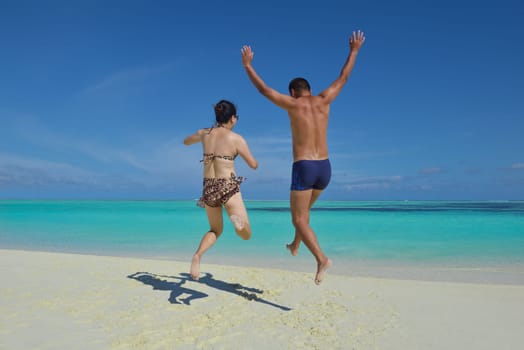happy young asian couple have fun and romantic time at  summer on beautiful white sand beach