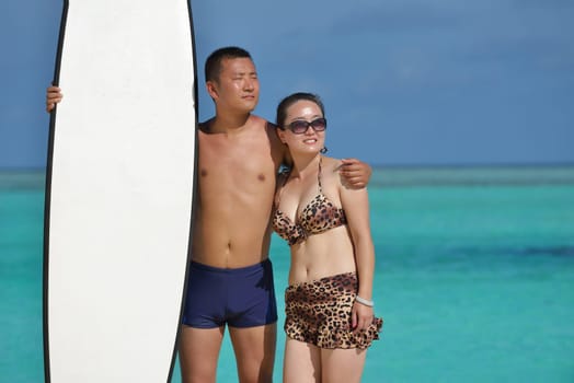 happy young asian couple have fun and romantic time at  summer on beautiful white sand beach
