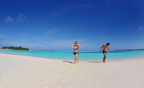 happy young asian couple have fun and romantic time at  summer on beautiful white sand beach