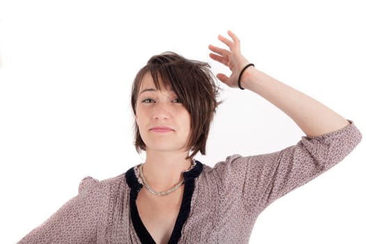 portrait of a young woman in grey dress playing with her hair on studio