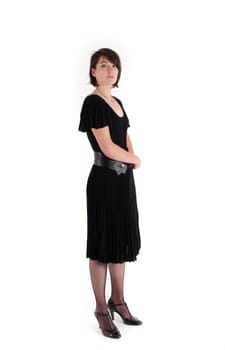 a young woman in strict black dress in studio looking like widow or nanny